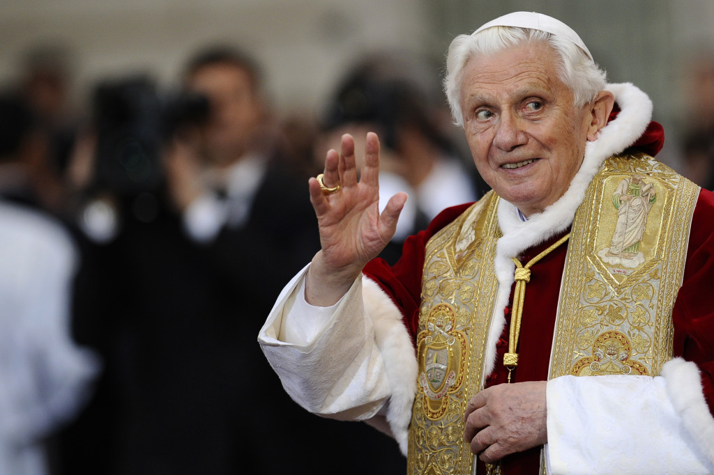 Pope Benedict XVI waves to faithful duri